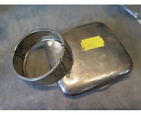 A white metal bangle and a silver cigarette case 