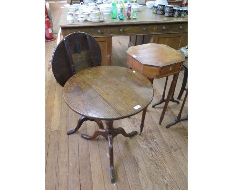 An early 19th century line inlaid fruitwood occasional table, the octagonal top with drawer over ring turned legs, 40 cm wide