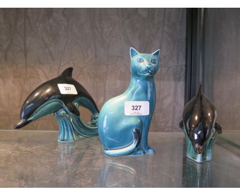 A Poole Pottery figure of a Dolphin, 14 cm high, another 11 cm high and a figure of a cat, 16 cm high 