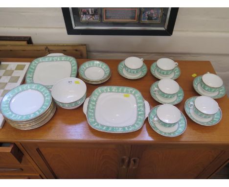 A Crown Staffordshire part tea service, the green borders depicting dancing figures, including six tea cups and saucers, two 
