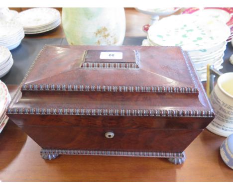 A Regency mahogany sarcophagus form tea caddy, containing original cut glass bowl and two lidded compartments, 35 cm wide, 22