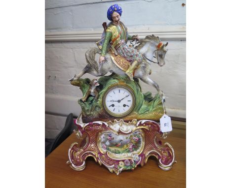 A 19th century French porcelain clock, depicting a Turk on horseback hunting a leopard, over an enamelled dial inscribed Hry 