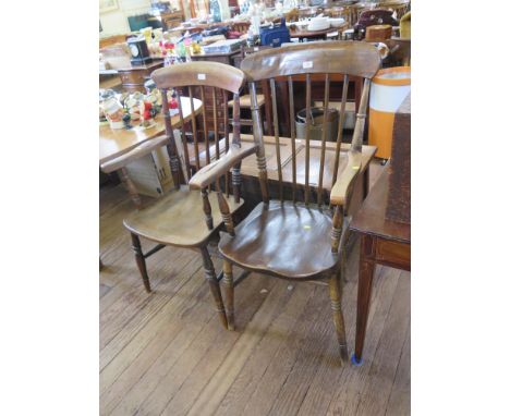 Two ash and elm kitchen armchairs, with spindle backs, moulded seats and ring turned legs, one joined with stretchers (2)