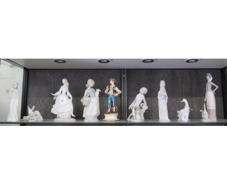 A Lladro figure of a boy with his dog, 19cm high, another of a lady with geese, four other Lladro figures, a Nao figure, anot