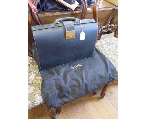 A Celine of Paris black leather briefcase, with compartments to the interior, unused and includes dust bag, 46 cm wide, 18 cm