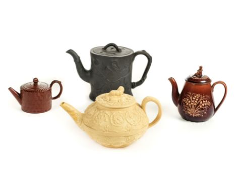 Teapots. An early 19th century black basalt teapot, probably Spode, relief moulded grape and vine decoration with conforming 