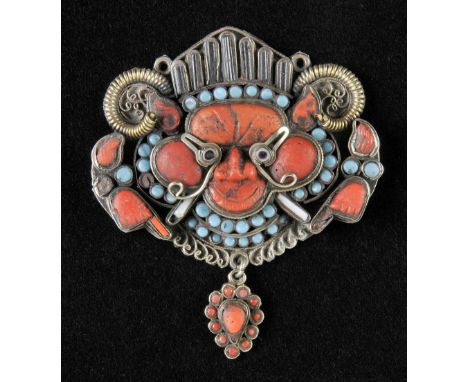 Pendant . A rare silver and jewelled Tibetan/Newari monster mask drop pendant, 18th/19th century, set with agate, coral, turq