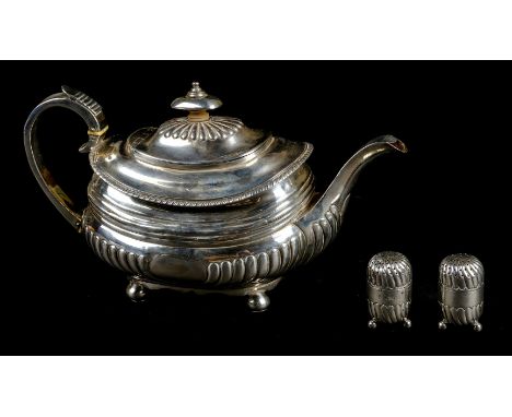 Teapot. A George III silver teapot, of oblong form with half gadrooned decoration, the lid with silver knop, on four ball fee