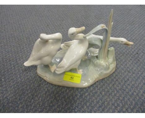 A Lladro model of geese by a pond 