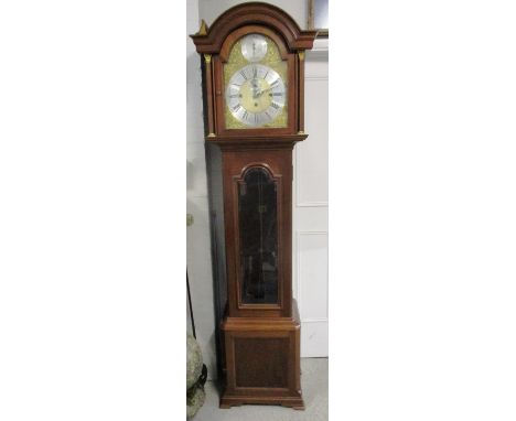 An early 20th century longcase clock, the Winterhalder chiming movement, striking on eight gongs with a 12 1/2" brass dial, i