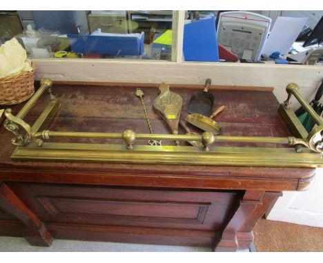 A late 19th century brass fire fender, 46" x 14 1/2", along with a bras clad and wooden fire bellows with embossed, ship desi