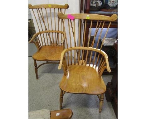 Two 20th century elm and mixed wood Windsor stick back armchairs with crinoline stretchers and turned legs 