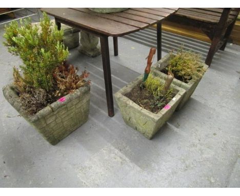 A large weathered stoneware planter of square form, and a pair of smaller similar planters 