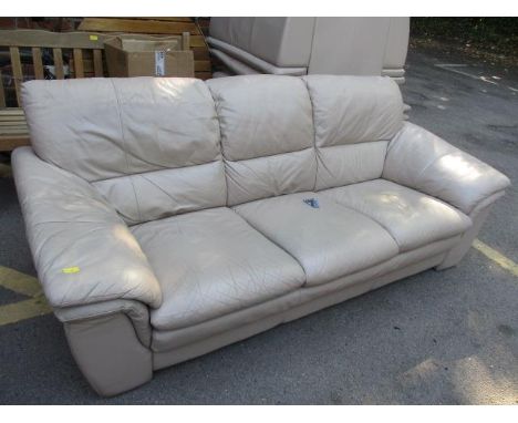 A cream leather sofa and two matching armchairs 