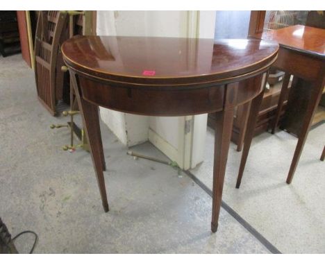 A George III string inlaid mahogany D-shaped card table with a brown leather surface, raised on square tapered legs, 29"h x 3