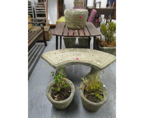 A stoneware garden bench, a pair of garden planters with plants, and a single stoneware planter of circular form 