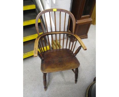 An early 20th century mahogany stick back armchair 