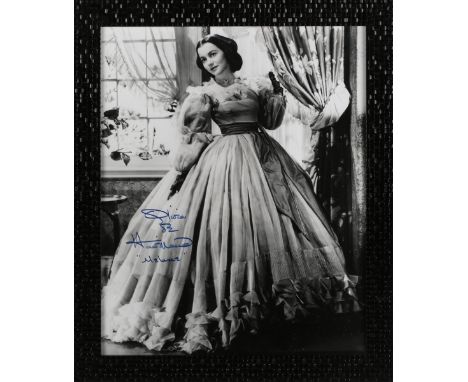 AUTOGRAPHS. An autographed black and white photograph of Olivia de Havilland, framed and signed in blue ink, 40.5cm x 32.5cm,