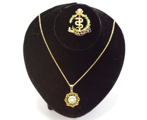 A 9ct gold circular pierced work pendant set with a central pearl and surrounded with round turquoise cabachons on a yellow m