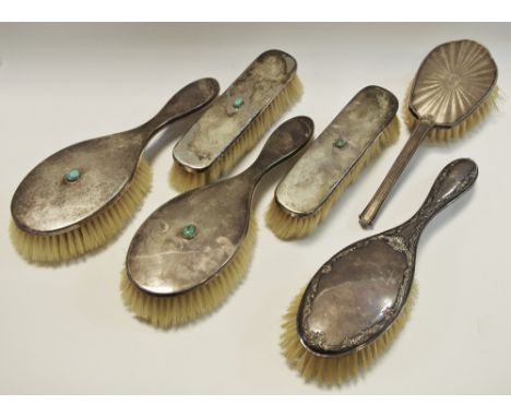 An early Edwardian silver backed dressing table set comprising two hairbrushes &amp; two clothes brushes each set with a cent