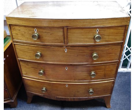 An early 19th century mahogany bow front chest of two short drawers over three graduated long, brass roundel handles, spreadi