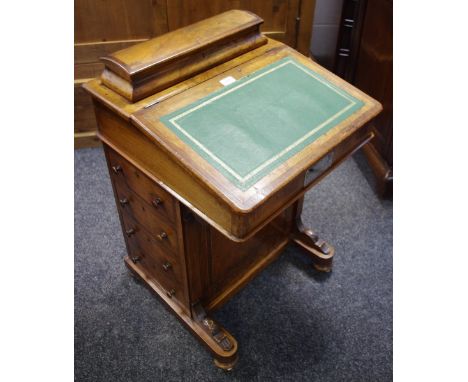 A walnut piano top davenport, by D R Baxter Kettering, leather inlaid slope, four drawers to the side, bun feet, ceramic cast