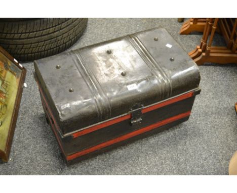 A dome topped tin trunk