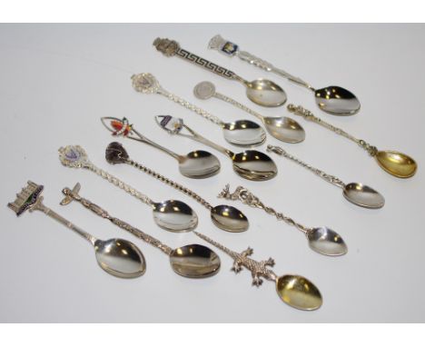 A collection of silver, enamel and plated souvenir and novelty spoons