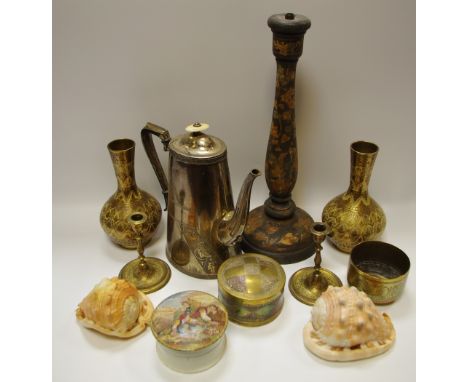 A conch shell carved with cameo; another; a polychrome wooden candlestick; eastern brassware.