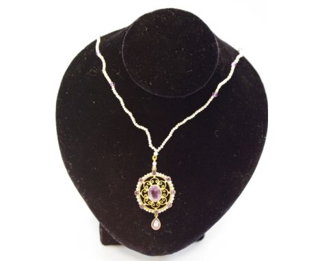 A 9ct gold filigree pendant set with an oval central amethyst, the outer set with seed pearls and round amethysts with a drop