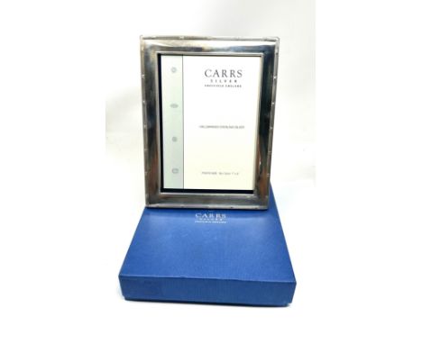 Boxed silver picture frame m easures approx 22cm by 17cm 