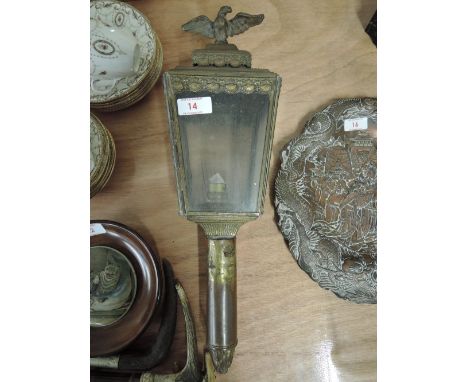 An early brass carriage lamp with a regency style adorned with a cast eagle 