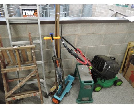 A selection of garden and work tools including saw and seed dispenser 