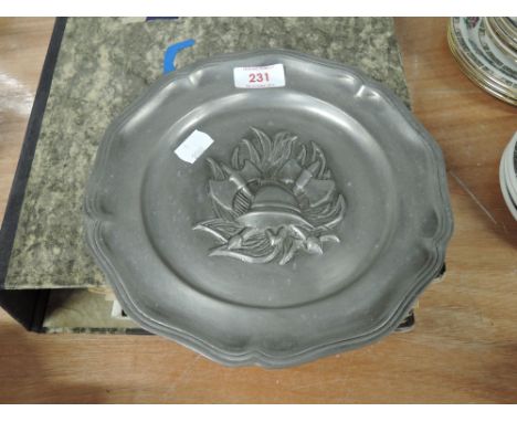 A pewter wall plate for display with fireman helmet flames and axe logo