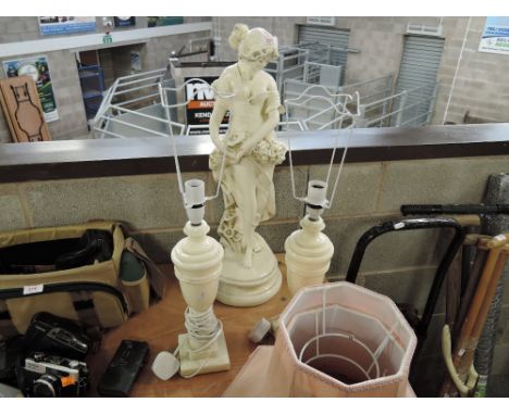 A large ceramic study of a young woman and two lamps