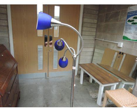 A modern chrome three branch standard lamp having blue glass shades