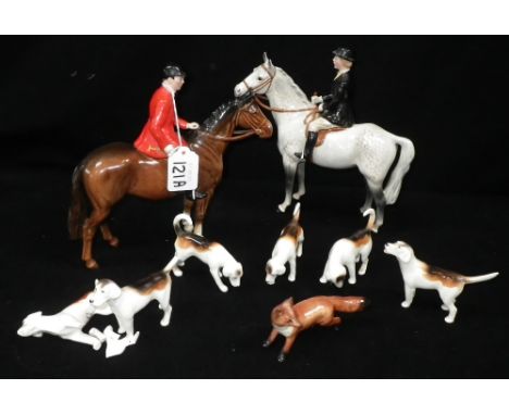 BESWICK: A FOX HUNTING GROUP COMPRISING: A HUNTSWOMAN ON A GREY DAPPLED HORSE, a huntsman on a brown horse, a fox and six hou