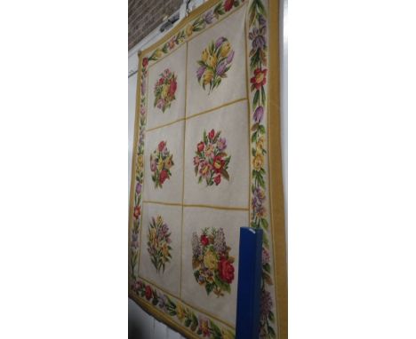 A LARGE NEEDLEWORK TAPESTRY decorated with floral sprays within a floral and yellow border, 52" wide x 73 high
