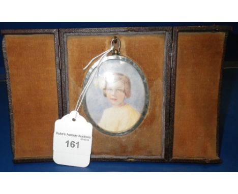 A PORTRAIT MINIATURE of a young girl, in leather covered frame