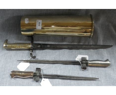 A FIRST WORLD WAR BRASS SHELL CASE and three 19th century and later bayonets (4) 