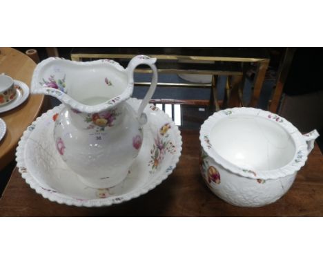 A CERAMIC WASH JUG, BASIN AND CHAMBER POT SET, with floral moulded and painted decoration, possibly Welsh (3)