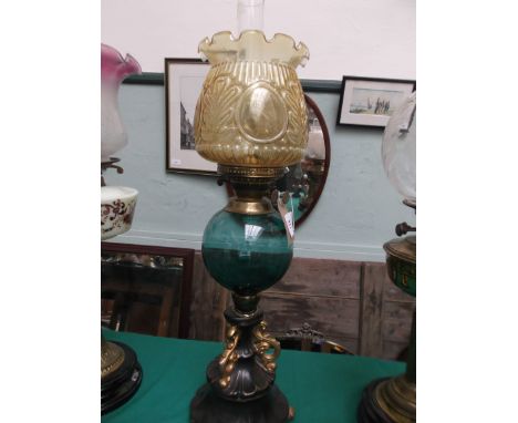 Ornate gilt and black painted based lamp with light clear glass blue bowl and an ornate shaped gold shade with chimney