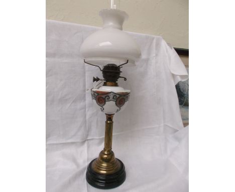 Circular black pot based table lamp with brass corinthian column, the white bowl shaped brown painted ornate designs with clo