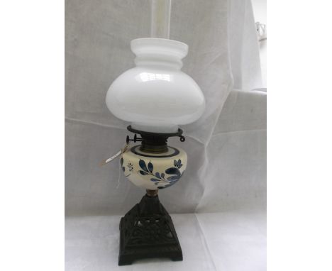Metal based lamp with cream bowl, had painted dark blue floral sprays, clouded white mushroom shaped shade and chimney