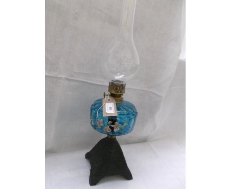 Metal based table lamp with floral hand painted panels to the light blue bowl and shaped chimney