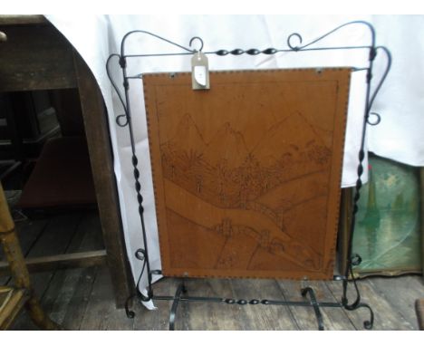 Metal framed firescreen, the wooden panel etched mountain scene