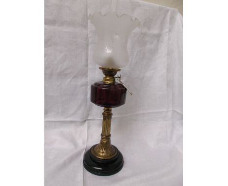 Circular pot based table lamp supported by brass corinthian column, the purple bowl with shaped etched glass shade and chimne