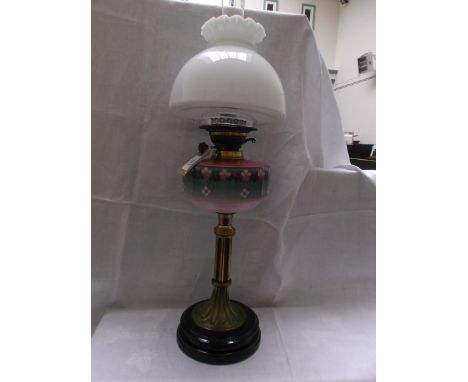 Circular black pot based lamp with brass column, the varying shades of pink to bowl decorated floral rosettes with mushroom c