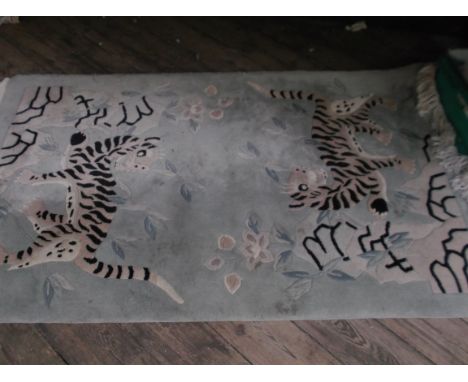 Tasseled light blue ground rug decorated with two tigers (36" x 60")