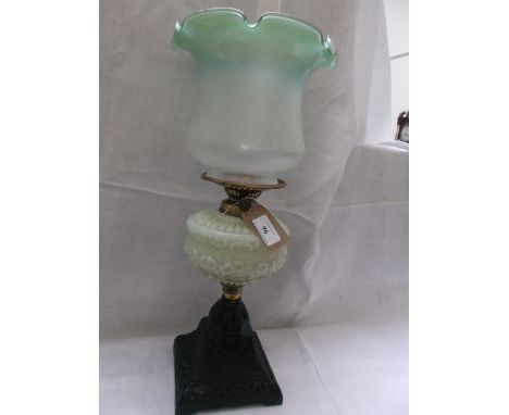 Metal based table lamp with clouded green glass bowl and an etched white and green border shade with chimney